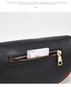 Detail of black leather waist bag featuring gold zipper and external storage pocket