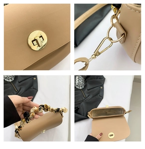 Detail view of apricot saddle bag with golden clasp and decorative silk handle