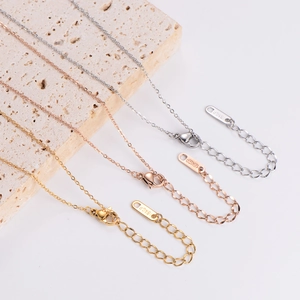Three minimalist QUEEN diamond necklaces in gold, rose gold, and silver 18KGP finish