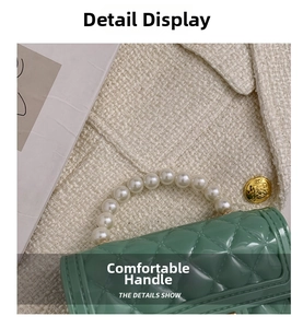 Detail of mint green jelly bag featuring pearl handle and quilted rhombus texture