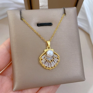 Detailed close-up of shell pendant necklace with white pearl and sparkling crystals