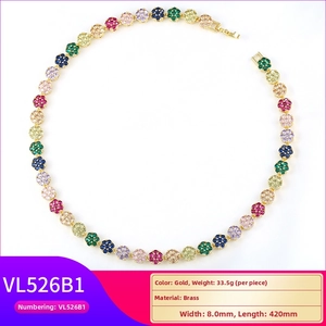 Detail of brass floral necklace featuring colorful crystals and gold plating finish