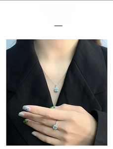 Detail of silver S925 necklace and ring set with blue square gemstones on a model