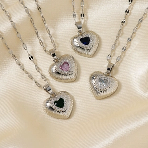 Elegant heart pendant necklaces with vibrant zircon stones on a champagne silk background