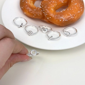 Macro shot showing variety of S925 sterling silver rings with cute heart and bow charms