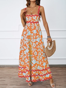 Detail of floral summer maxi dress featuring bright orange fabric and red wavy trim details