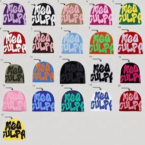 Grid display of 21 colorful Y2K style knitted beanies with Mea Culpa jacquard lettering