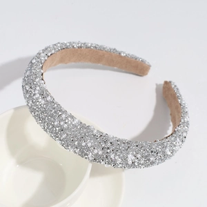 Detailed view of rhinestone and pearl headband with silver shimmering finish and soft lining