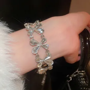 Elegant silver bracelet with teardrop crystals and adjustable chain on model's wrist