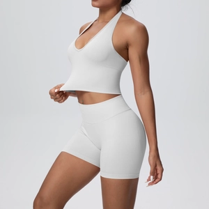 Detailed side view of white halter-neck sports bra and high-waist fitness shorts set