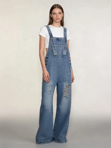 Women's vintage light blue distressed denim overalls with wide legs and ripped detail