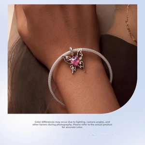 Detail of s925 silver mesh bracelet featuring hollow butterfly and pink heart charm