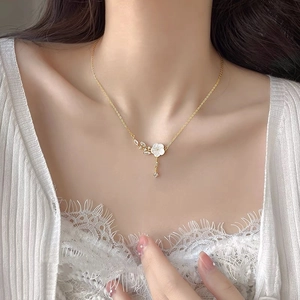 Elegant S925 silver necklace with white flower tassel pendant on a model neck