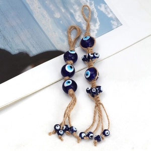 Exotic Evil Eye heart pendant with blue glass beads and natural hemp rope tassels