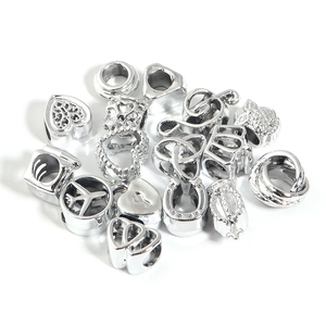 Silver alloy heart and owl charms for DIY jewelry making on white background