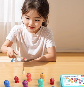 Little girl playing with magnetic wooden fishing toy set from a blue metal storage box