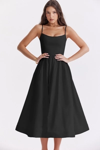 Close-up of black spaghetti strap dress with a slim waist and flared A-line skirt