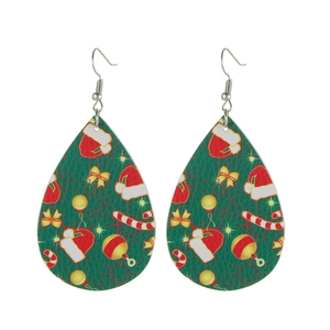Close-up of green teardrop leather earrings with festive Christmas tree patterns