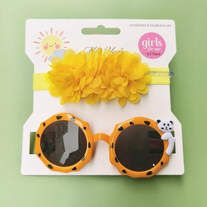 Close-up of orange leopard print toddler sunglasses with bear and floral headband set