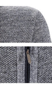 Detail of dark grey knit sweater showing shoulder texture and VOGUE engraved metal zipper