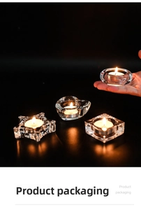 Macro shot of assorted heart and star glass tealight holders with flickering candles