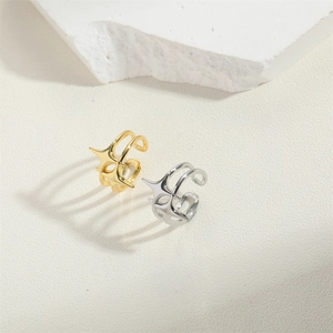 Minimalist double-layer star rings in gold and silver finish shown from a 45-degree angle