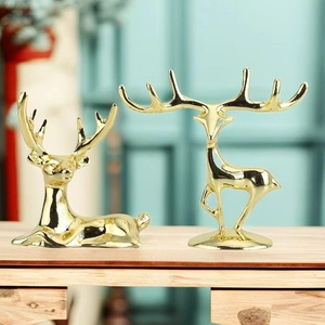Elegant gold metal deer figurines in standing and sitting poses for luxury home decor