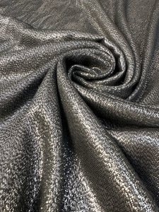 Detail shot of the dark grey shimmering metallic fabric texture with elegant drape