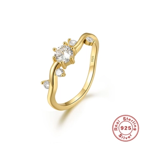 Detail view of wavy gold-plated S925 sterling silver ring with sparkling zircon stones
