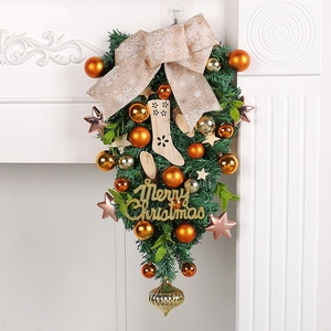 Elegant Christmas teardrop swag featuring orange gold balls and a burlap snowflake bow