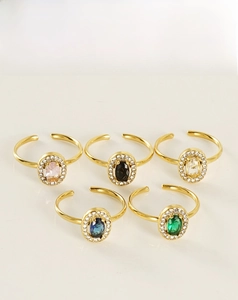Detailed top view of five adjustable 18K gold plated stainless steel oval gemstone rings