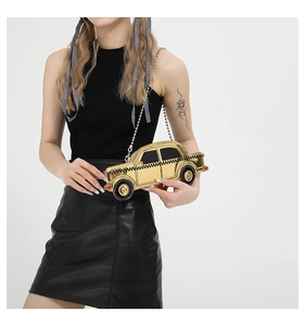 Chic gold taxi-shaped clutch bag with checkered detail and silver metal chain strap