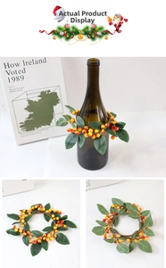 Detailed view of orange and yellow berries wreath with artificial leaves for home decor