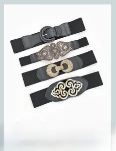 Detail showing four vintage metal buckles on wide black elastic belts with weave texture