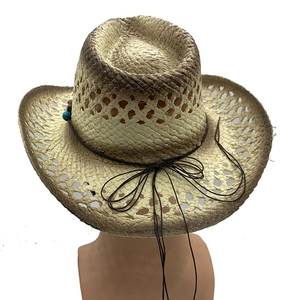 Detail of straw cowboy hat featuring bead accents and breathable hollow weave design