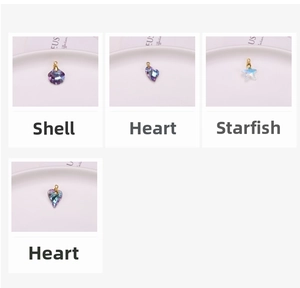 Detailed grid of colorful AB crystal shell, heart, and starfish charms with gold loops