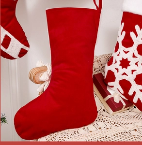 Detail of a plush red velvet Christmas stocking on a lace-decorated chair for holiday decor