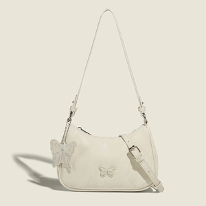 Elegant cream butterfly underarm bag with embossed pattern and matching pendant