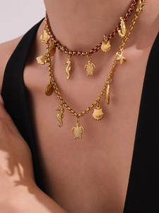Detail view of double-layer ocean necklace with seahorse, shell and turtle charms