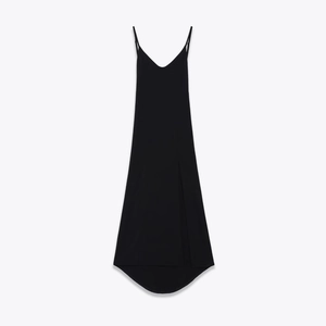 Minimalist black maxi dress with spaghetti straps and side slit on white background