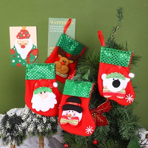 Set of 4 Christmas stockings with Santa, reindeer, snowman and bear hanging on a tree