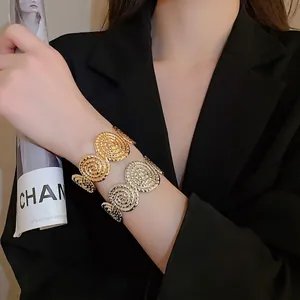 Textured metal open bangles in gold and silver finish with spiral ribbed design