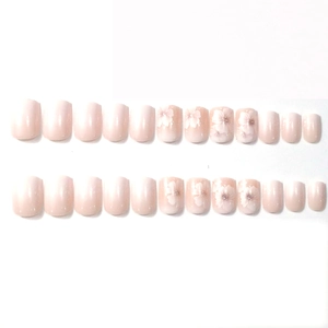 Short square press-on nails featuring nude pink French gradient and white floral patterns