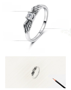 Macro detail of 925 sterling silver angel wing ring with 5A zircon inlay and hand-polished finish
