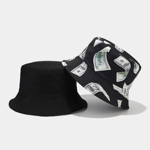 Detail of a dollar bill print bucket hat and black canvas hat with sharp focus