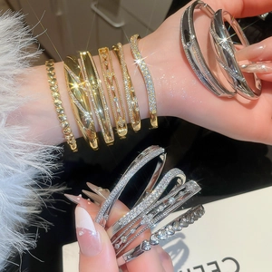 Macro detail of 18k gold plated bracelets with zircon inlay for elegant daily wear