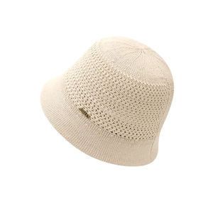 Beige knit bucket hat for women with JSHAT metal logo on a clean white background