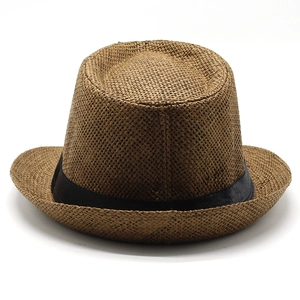 Detail of a brown woven straw fedora with a classic black grosgrain ribbon band