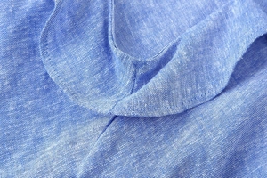 Close-up of neckline detail on a breathable blue linen-blend layered sundress