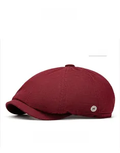 Detail of wine red newsboy cap with textured knit fabric and silver side button